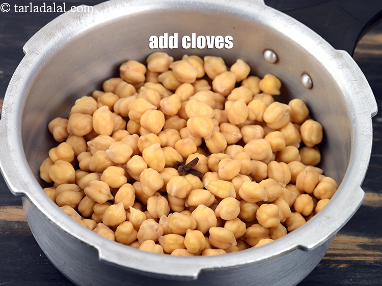Step 5 – Add 3 <a href="https://tarladalal.com/glossary-cloves-laung-lavang-322i">cloves (laung / lavang)</a>.