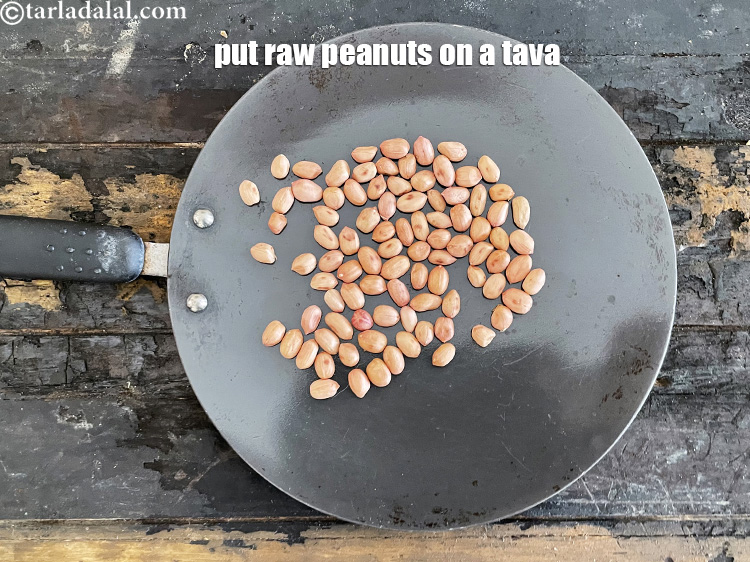 Step 23 – Place raw peanuts on a tava as we are going to roast them.