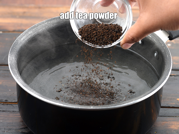 Step 4 – Add 4 tsp <a href="https://www.tarladalal.com/glossary-tea-powder-2185i">tea powder (chai ki patti)</a>. Always use mild tea powder.