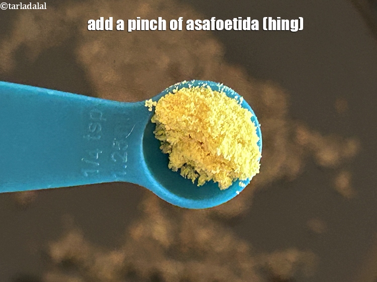 Step 5 – Add&nbsp;<meta charset="UTF-8" />a pinch of&nbsp;<a href="glossary-asafoetida-hing-113i">asafoetida (hing)</a>.