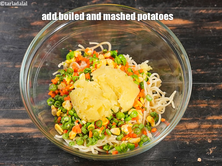 Step 5 – Add 1/4 cup boiled and <a href="https://www.tarladalal.com/glossary-boiled-and-mashed-potatoes-1831i">mashed potatoes</a>.