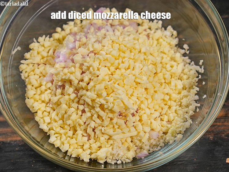 Step 5 – Add &frac12; cup <a href="https://www.tarladalal.com/glossary-diced-mozzarella-cheese-2805i">diced mozzarella cheese</a>.
