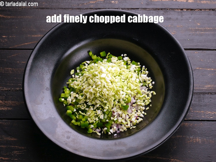 Step 5 – Add &frac14; cup finely <a href="https://www.tarladalal.com/glossary-chopped-cabbage-781i">chopped cabbage</a>.