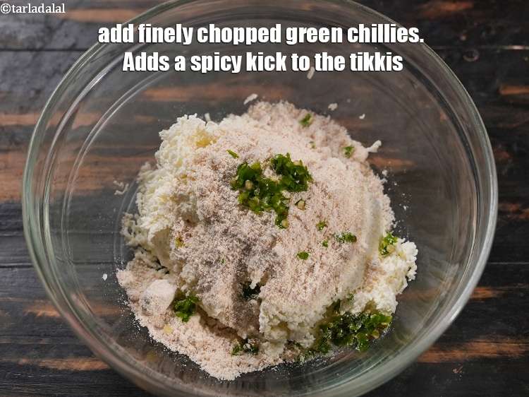 Step 5 – Add 1 tsp finely <a href="https://www.tarladalal.com/glossary-chopped-green-chilli-820i">chopped green chillies</a>. Adds a spicy kick to the tikkis.