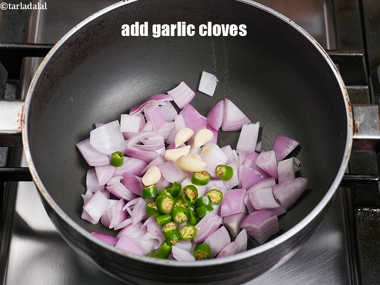 Step 5 – Add 6 <a href="https://www.tarladalal.com/glossary-garlic-cloves-1857i">garlic (lehsun) cloves</a>.