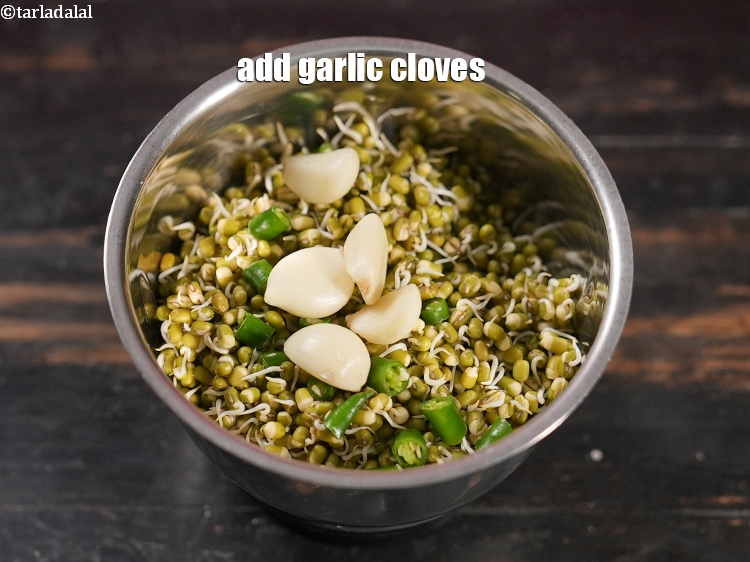Step 5 – Add 4 to 5 <a href="https://www.tarladalal.com/glossary-garlic-cloves-1857i">garlic (lehsun) cloves</a>.