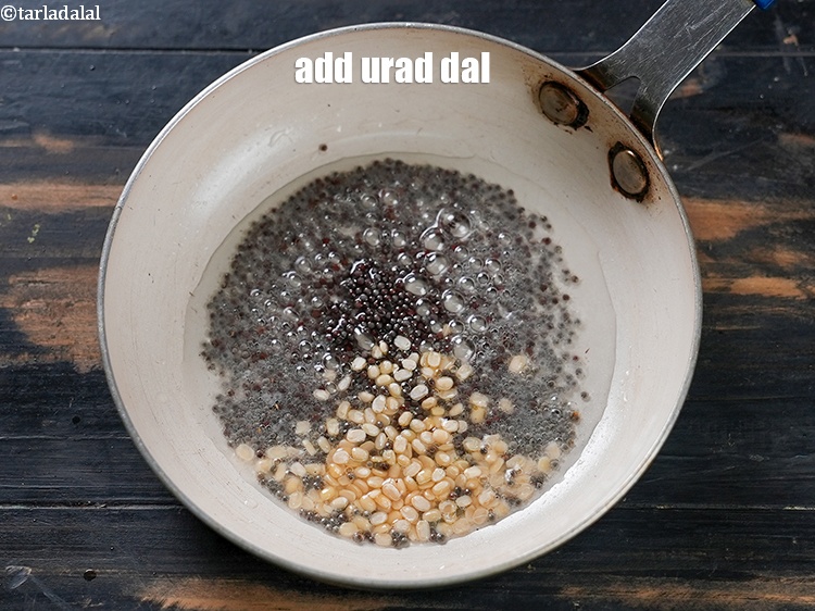 Step 5 – Add &frac12; tsp <a href="https://www.tarladalal.com/glossary-urad-dal-split-black-lentil-941i">urad dal (split black lentils)</a>.