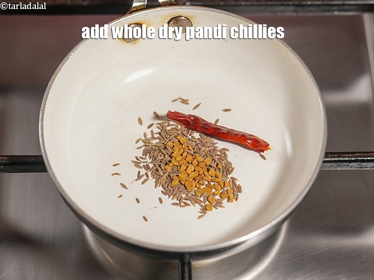 Step 5 – Add 1 whole dry <a href="https://www.tarladalal.com/glossary-pandi-chillies-pandi-dry-red-chillies-2373i">pandi chillies</a>.