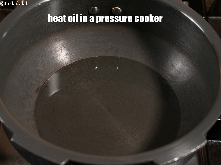 Step 5 – Heat 2 tbsp oil in a pressure cooker.