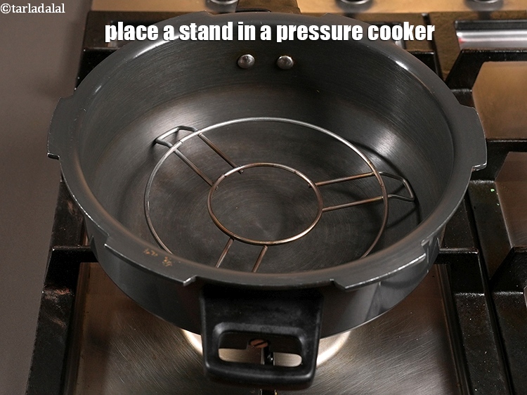 Step 5 – Place a stand in a pressure cooker.