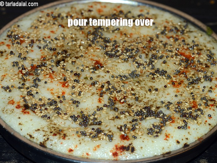 Step 33 – Pour the tempering over the stuffed rava dhokla.&nbsp;