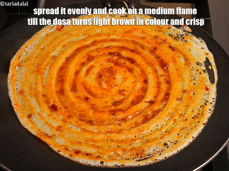 Step 32 – Spread it evenly and cook on a medium flame till the dosa turns light brown …