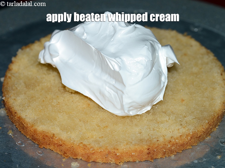 Step 34 – Apply &frac12; cup <a href="https://www.tarladalal.com/glossary-beaten-whipped-cream-1948i">beaten whipped cream</a>.