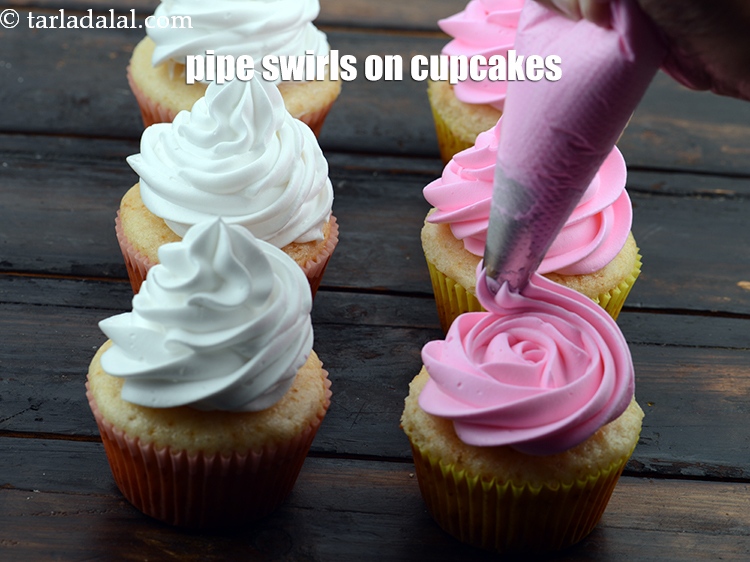 Step 32 – Pipe the swirls on the cupcakes.