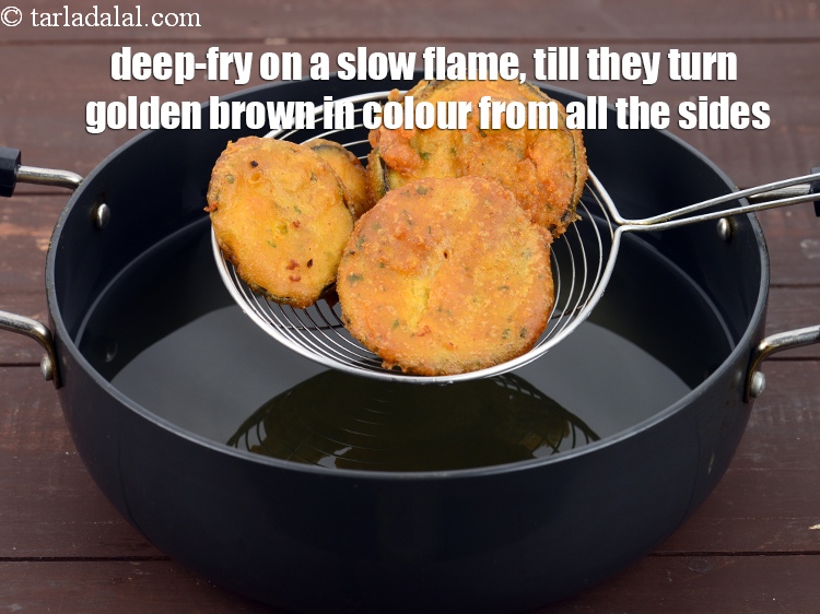 Step 39 – Deep-frying the pakodas on a slow flame is important so the brinjal cooks well.&nbsp;&nbsp;