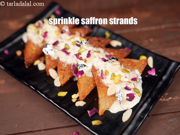 Step 33 – Sprinkle&nbsp;<a href="https://www.tarladalal.com/glossary-saffron-kesar-520i">saffron (kesar) strands</a>.