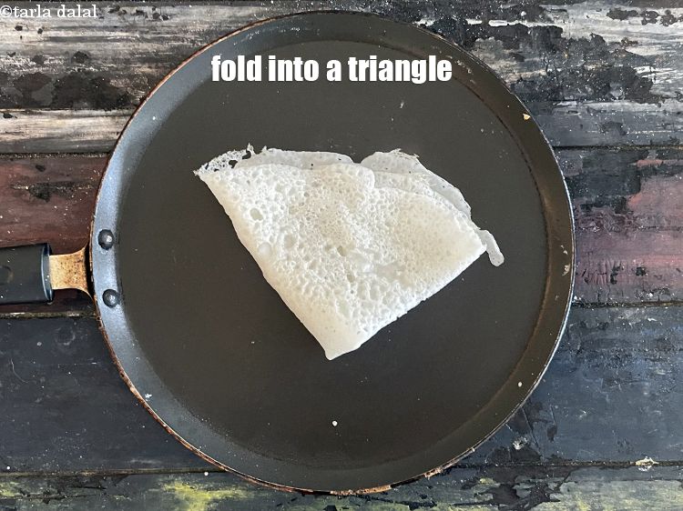 Step 32 – Fold the dosa into a triangle.&nbsp;Repeat with the remaining batter to make 9 more <strong>neer …