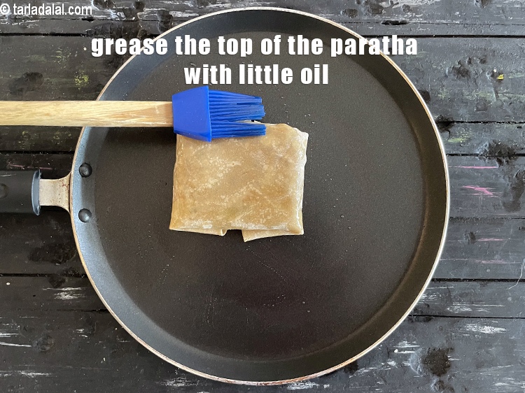 Step 51 – Grease the top of the paratha with little oil.