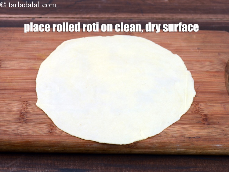 Step 34 – Place a rolled roti on a clean, dry surface.