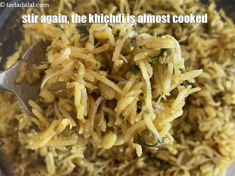 Step 33 – Stir again. You can see that the khichdi is almost cooked.