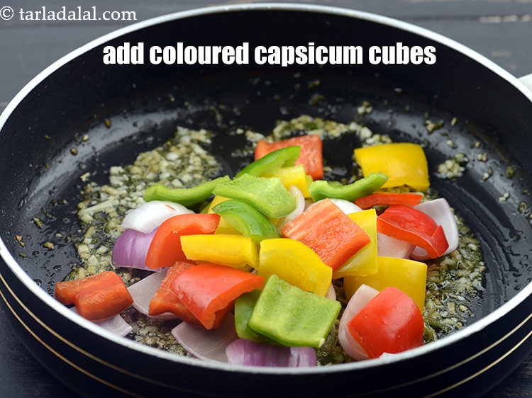 Step 32 – Add 1 cup coloured&nbsp;<a href="https://www.tarladalal.com/glossary-capsicum-cubes-170i">capsicum cubes</a>.