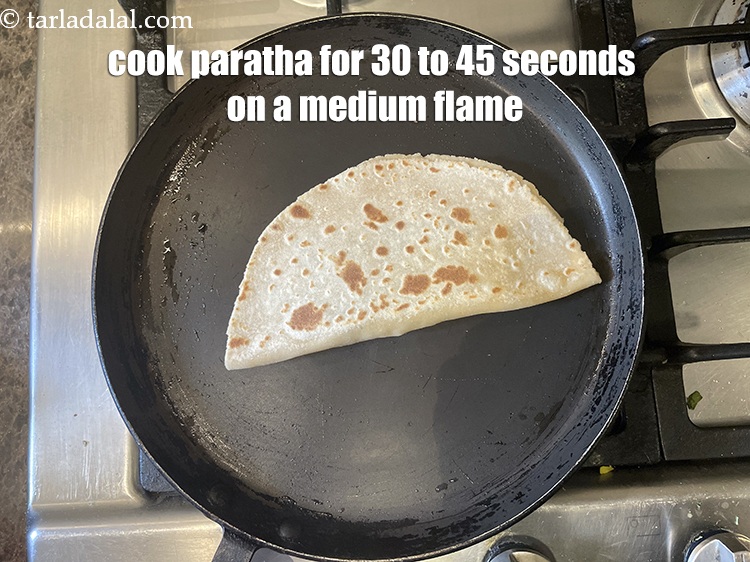 Step 34 – <meta charset="UTF-8" />Cook paratha for 30 to 45 seconds on a medium flame.&nbsp;&nbsp;&nbsp;<br /> &nbsp;