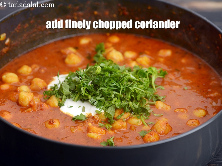 Step 33 – Add &frac14; cup finely <a href="https://tarladalal.com/glossary-chopped-coriander-783i">chopped coriander (dhania)</a>.