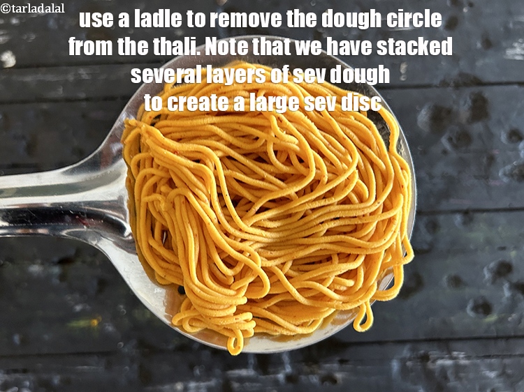 Step 33 – Use a ladle to remove the dough circle from the thali.&nbsp;Note that we have stacked …