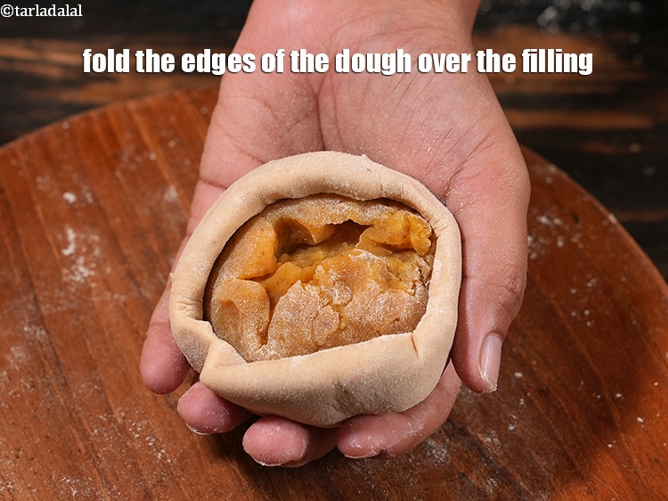 Step 33 – Fold the edges of the dough over the filling.
