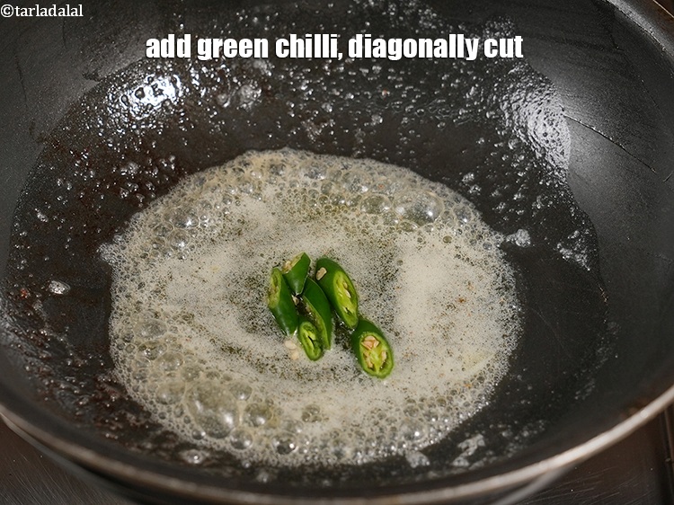 Step 33 – Add 1 <a href="https://www.tarladalal.com/glossary-green-chillies-hari-mirch-331i">green chilli</a>,&nbsp;diagonally cut.