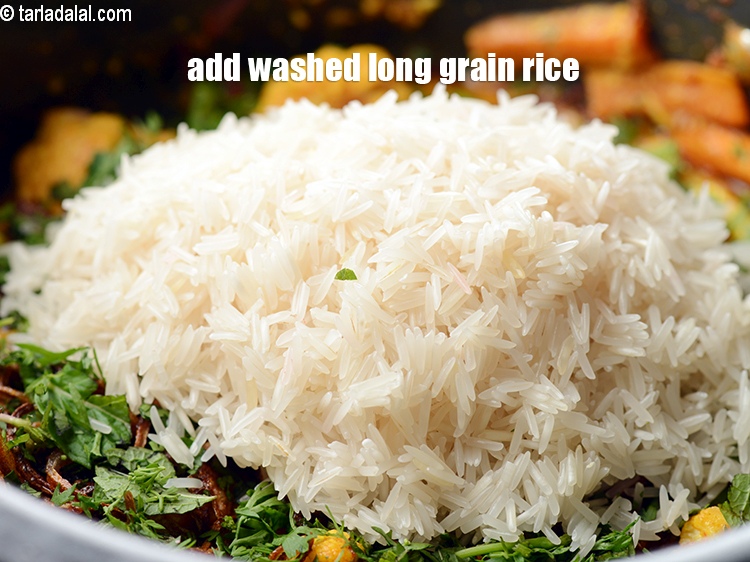 Step 33 – Add 1&frac14; cup washed <a href="https://www.tarladalal.com/glossary-long-grain-rice-basmati-chawal-basmati-rice-535i">long grain rice (basmati chawal)</a>.