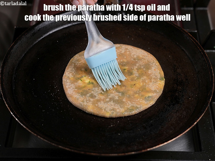 Step 36 – Brush the paratha with 1/4 tsp oil and cook the previously brushed side of&nbsp;paratha well.