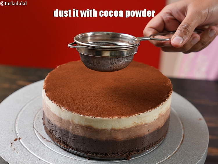 Step 33 – Dust it with <a href="https://www.tarladalal.com/glossary-cocoa-powder-284i">cocoa powder</a>.