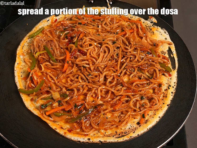 Step 33 – Spread a portion of the stuffing over the dosa.