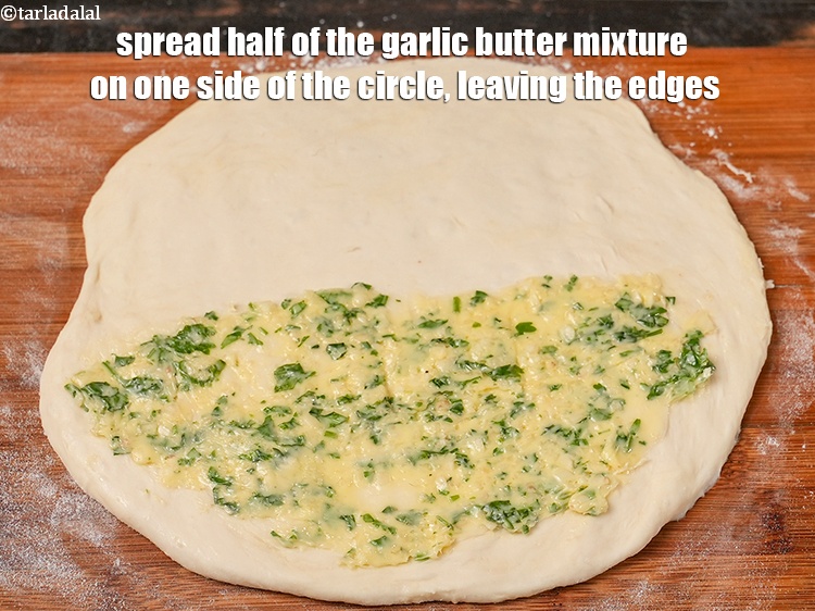 Step 34 – Spread half of the garlic butter mixture on one side of the circle, leaving the …