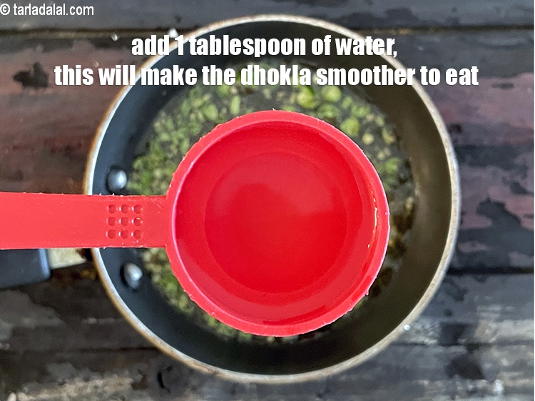 Step 33 – Add 1 tbsp of water. Water is added to make the dhokla soft and&nbsp;&nbsp;smoother on …
