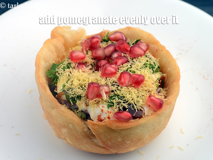 Step 35 – Add 1 tsp <a href="https://www.tarladalal.com/glossary-pomegranate-anar-587i">pomegranate (anar)</a> evenly over it.