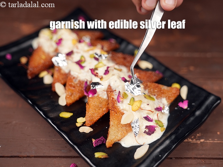 Step 34 – Garnish with <a href="https://www.tarladalal.com/glossary-edible-silver-leaf-613i">edible silver leaf (vark)</a>.