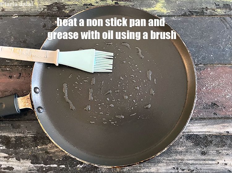 Step 49 – Heat a non-stick tava (griddle) and grease with oil using a brush.