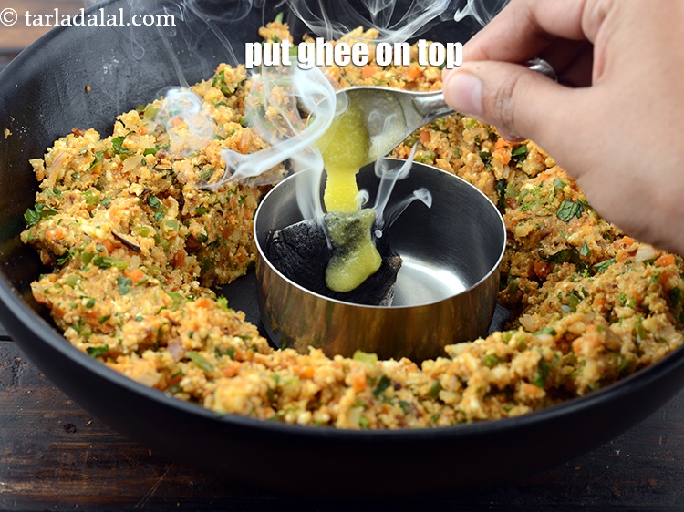 Step 33 – Put 1 tsp ghee on top of hot charcoal.