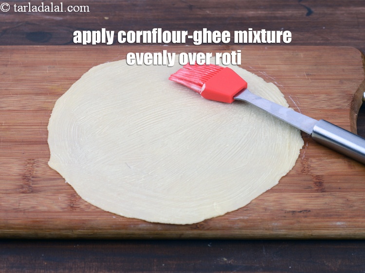 Step 35 – Apply 2 tsp of the cornflour-ghee mixture evenly over the roti.