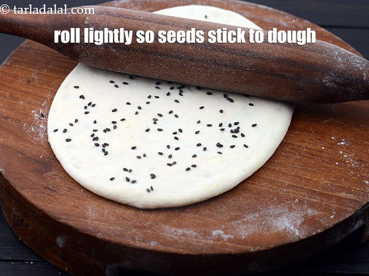 Step 35 – Roll once more lightly so the seeds stick to the dough.&nbsp;