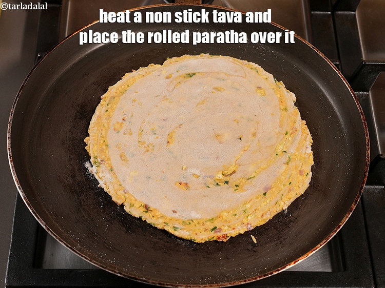 Step 34 – Heat a non stick tava and place the rolled paratha over it.