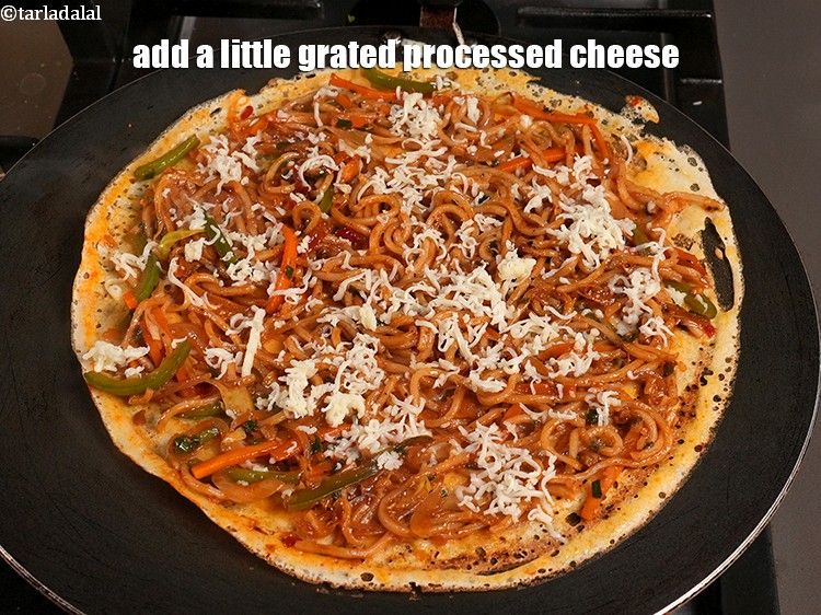 Step 34 – Add a little <a href="https://www.tarladalal.com/glossary-grated-processed-cheese-868i">grated processed cheese</a>.