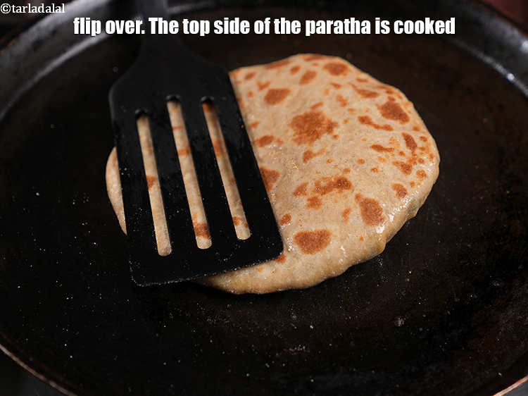 Step 37 – Flip over. The top side of the paratha is cooked.