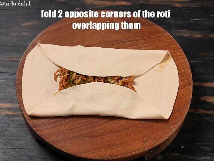 Step 34 – Fold 2 opposite corners of the roti over the filling, overlapping them slightly.
