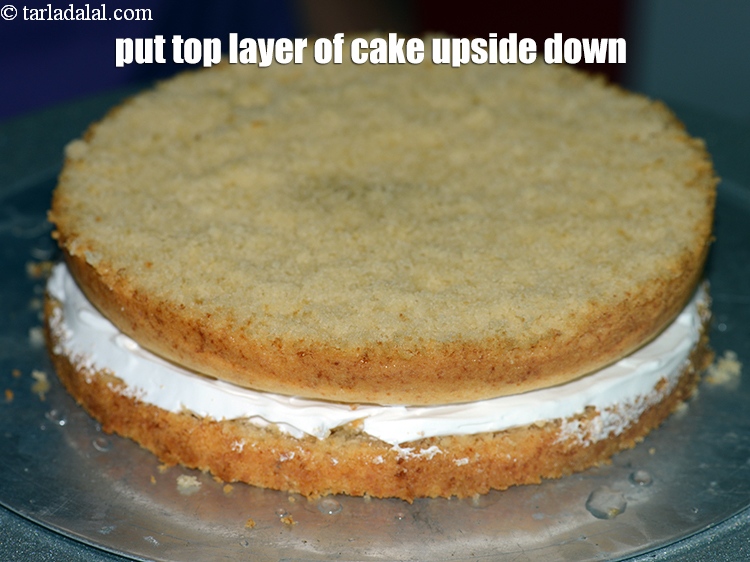 Step 36 – Put the top layer of the cake upside down over the whipped cream. Press it …