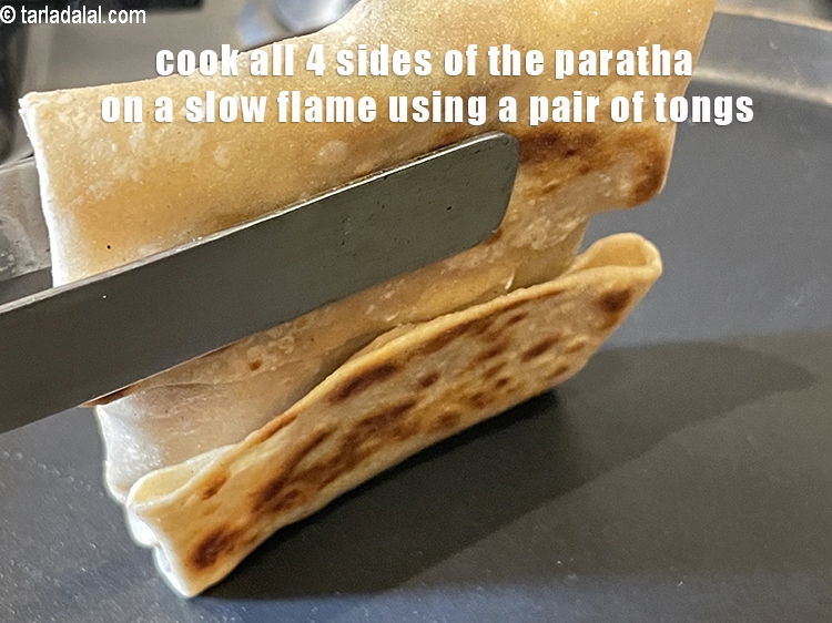 Step 53 – <meta charset="UTF-8" /> Cook all 4 sides of the paratha on a slow flame using …