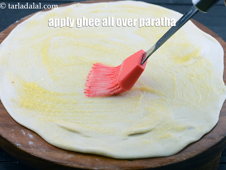 Step 41 – Apply 1 tsp <a href="https://www.tarladalal.com/glossary-ghee-245i">ghee</a>&nbsp;all over the paratha.