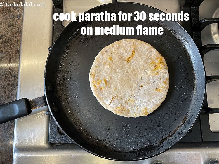Step 38 – <meta charset="UTF-8" /> Cook paratha for 30 seconds on a medium flame.&nbsp;